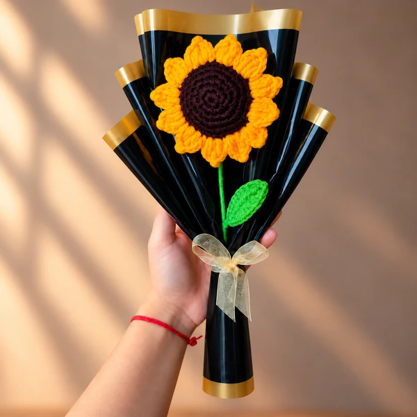 Crochet sunflower bouquet with one sunflower in black and gold wrap